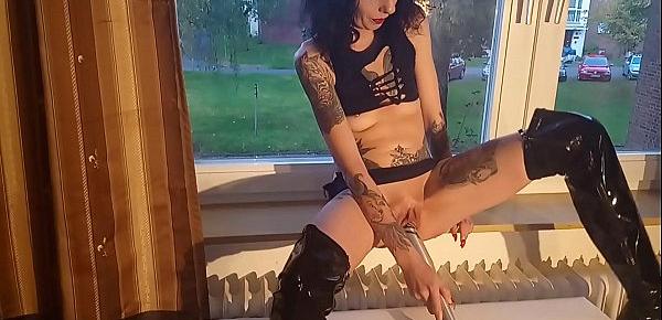  Horny whore fucks herself with the baseball bat at the window for the neighbors